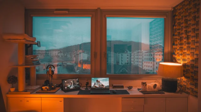 Open window letting in soft daylight onto a desk